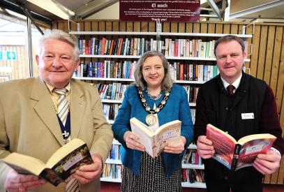 Lion President John Gee with the Chairman of the District Council and Manager of the Garden Centre at the official launch of the bookshop in their cafe.