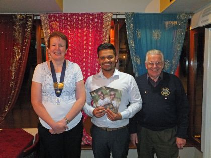Lion President Sarah Dorrington and First Vice President John Carter with Mutahar Hussain of the Shapla